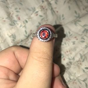 Beautiful red ring with diamonds around